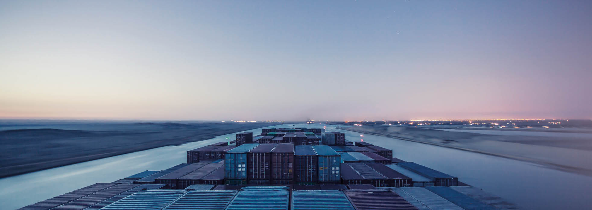 Container ship passing through the Suez Canal in the early hours of morning.